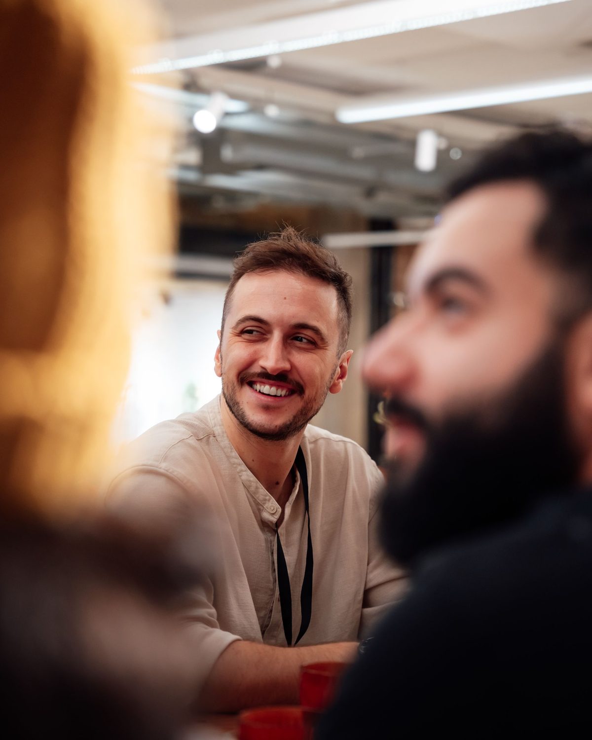 Two colleagues in conversation across a table in a modern London office